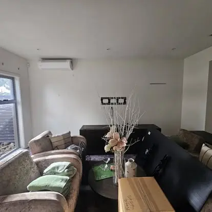 Finished lounge room with light walls, timber-look flooring and sofas